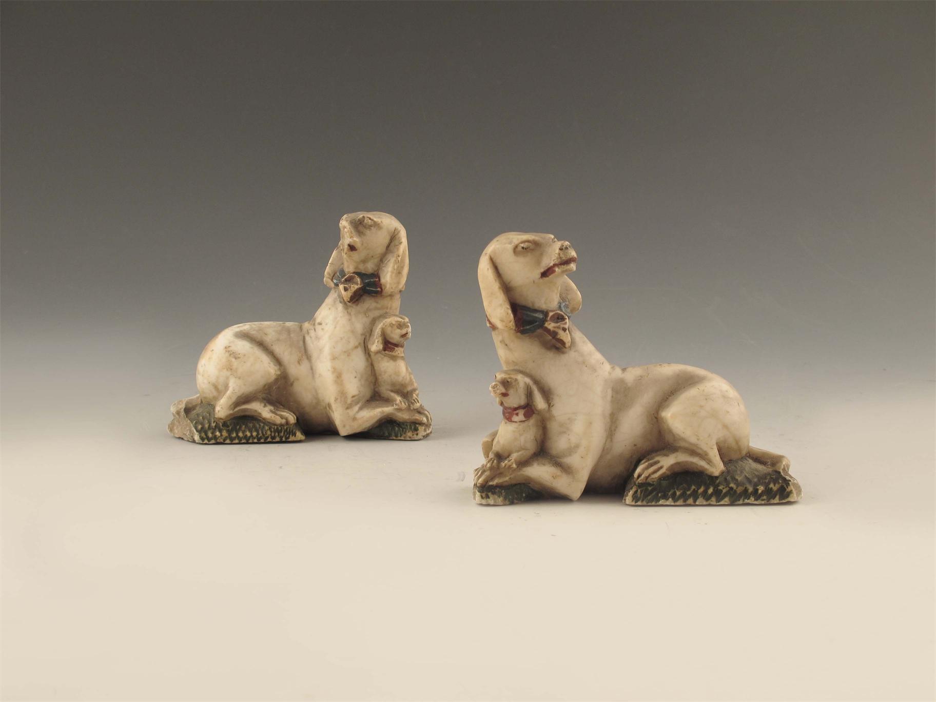 Appraisal: A pair of carved alabaster dog and puppy groups