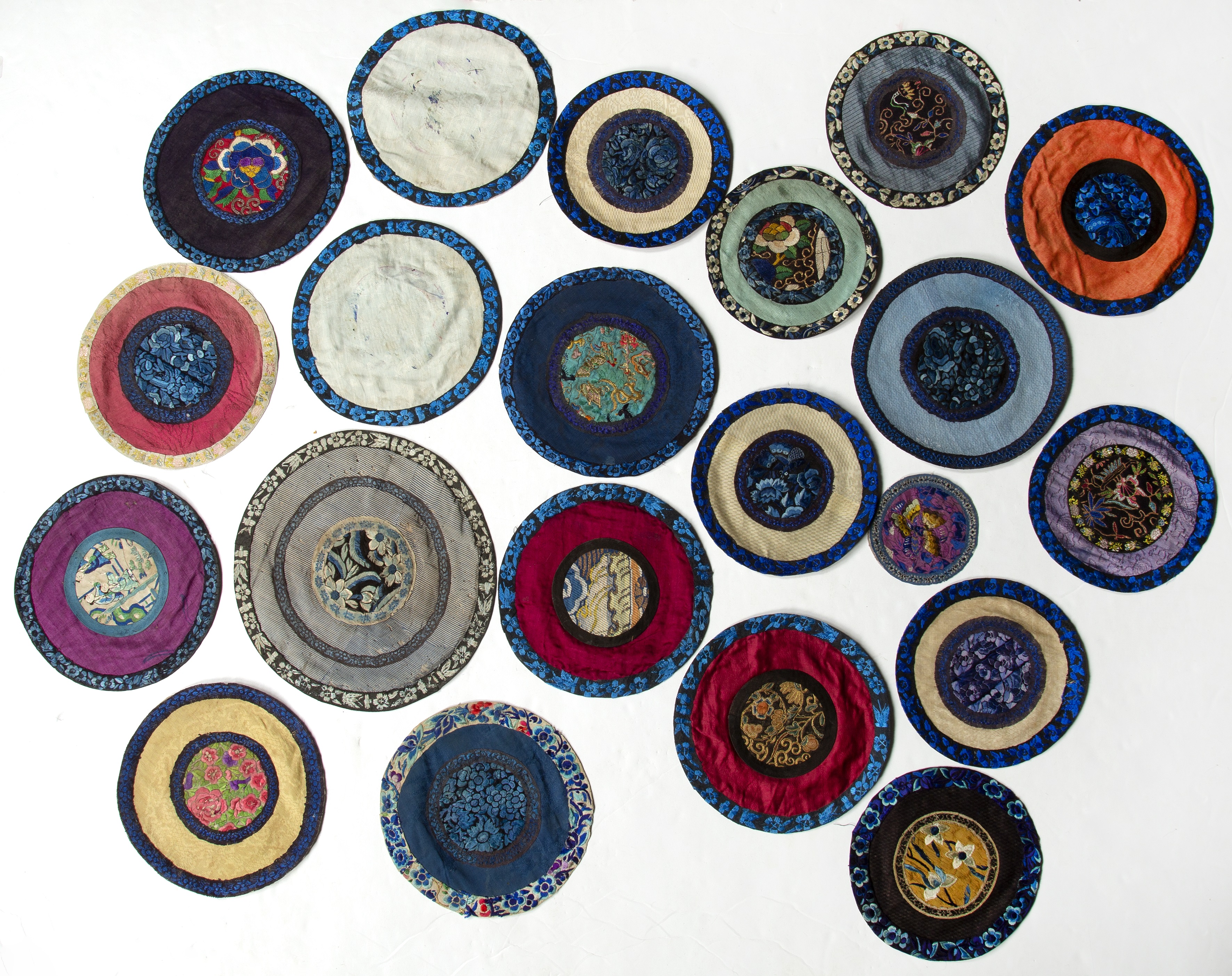 Appraisal: Group of twenty-one embroidered table mats Chinese of circular form