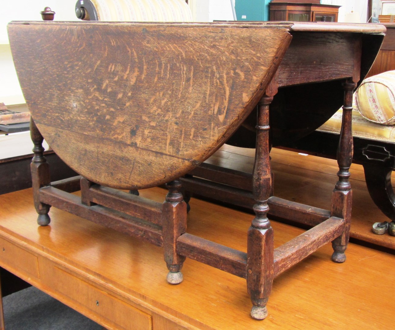 Appraisal: A th century oak oval drop flap table on baluster