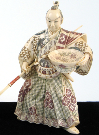 Appraisal: A JAPANESE IVORY CARVED FIGURE OF A SAMURAI holding large