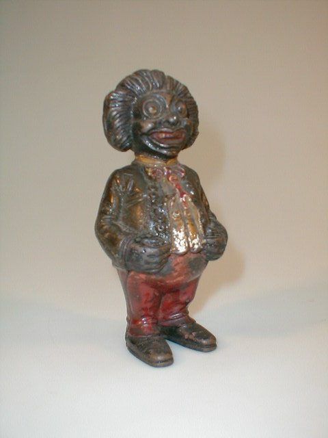 Appraisal: A cast metal money box as a gollywog