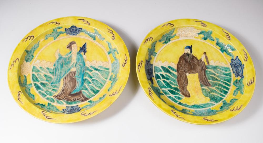 Appraisal: TWO CHINESE POTTERY SANCAI CHARGERS each featuring relief figures on