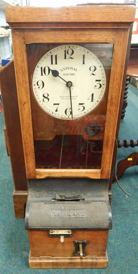 Appraisal: A National Electric clocking in clock in oak case the