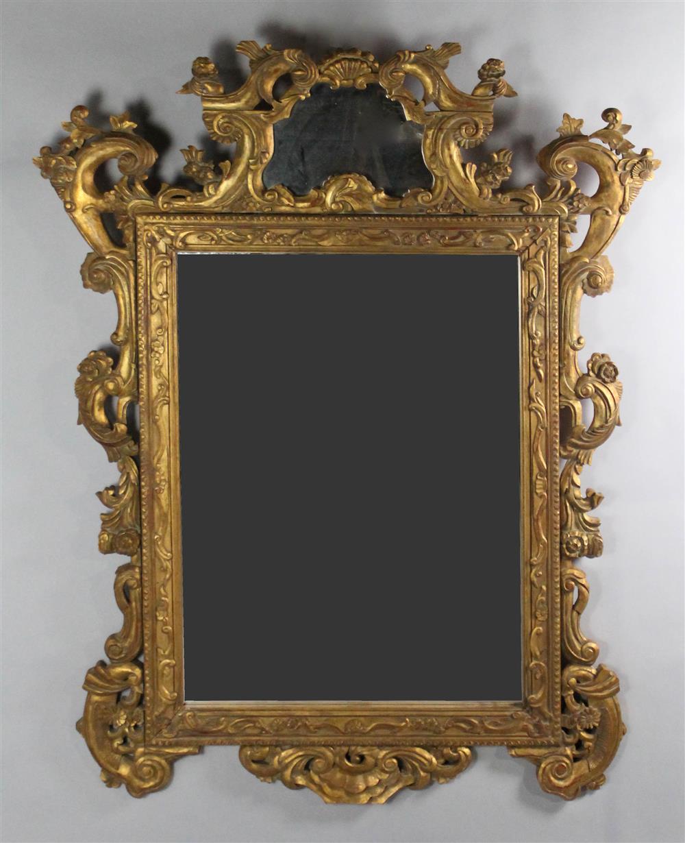 Appraisal: LARGE CONTINENTAL CLASSICAL REVIVAL STYLE GILTWOOD MIRROR the heavily carved