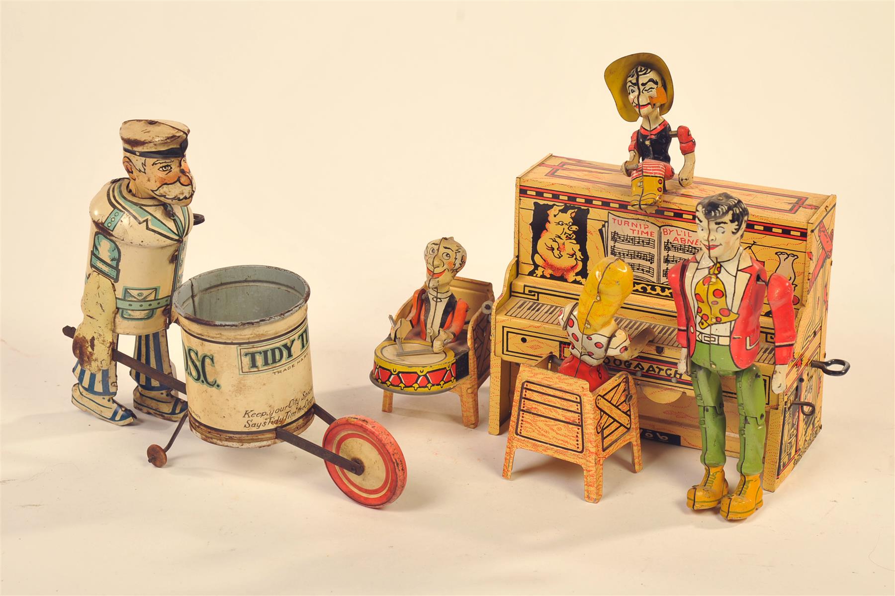 Appraisal: TWO TIN TOYS INCLUDING TIDY TIM AND LIL' ABNER BAND