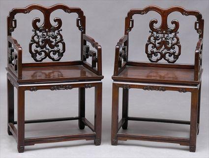 Appraisal: PAIR OF CHINESE CARVED HARDWOOD ARMCHAIRS Each waved top rail