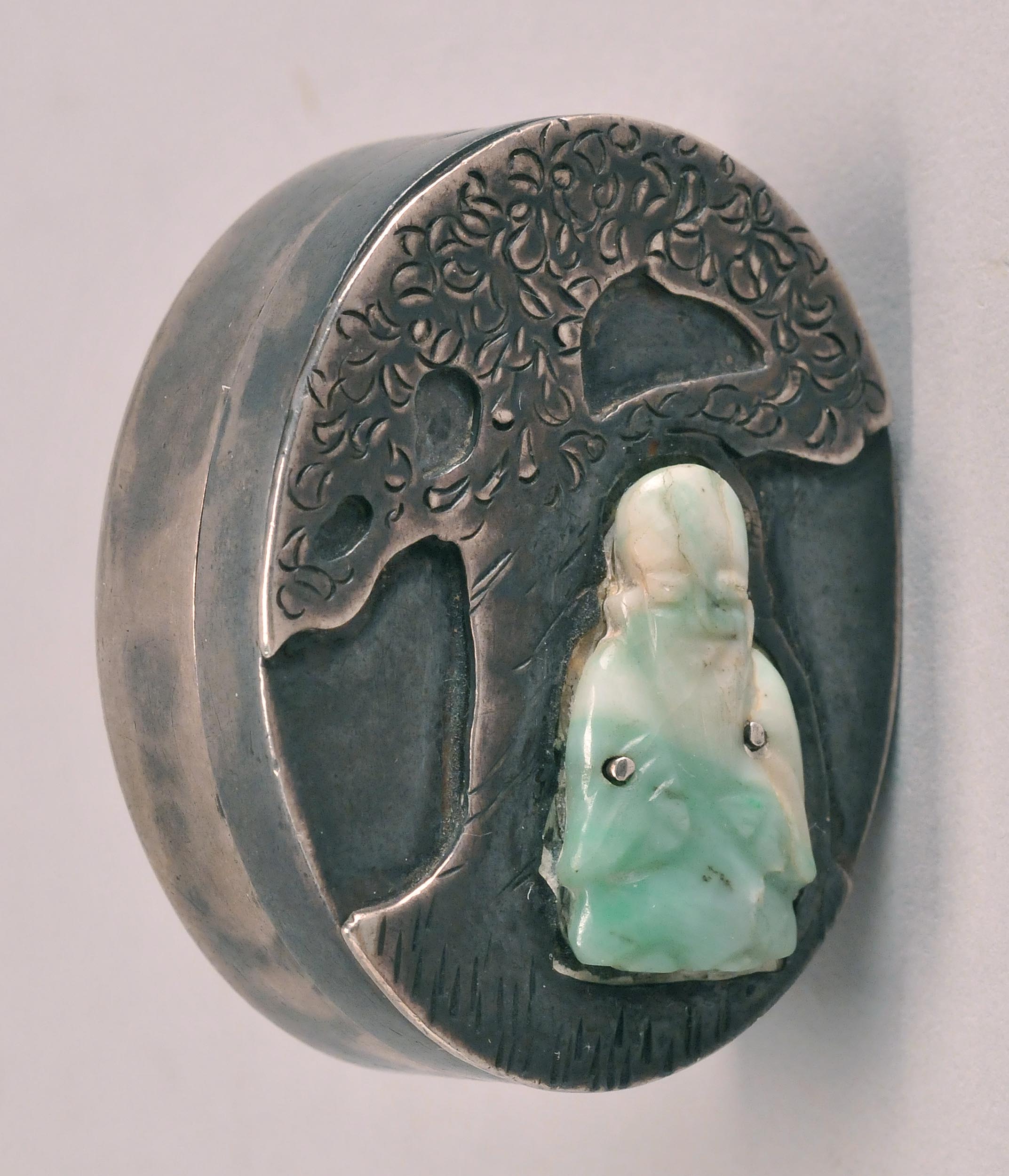 Appraisal: JADE-MOUNTED SILVER PILL BOX Circa In oval form depicting Joss