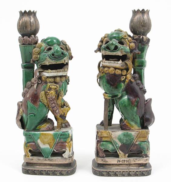 Appraisal: A pair of Chinese silver mounted glazed earthenware fu dog