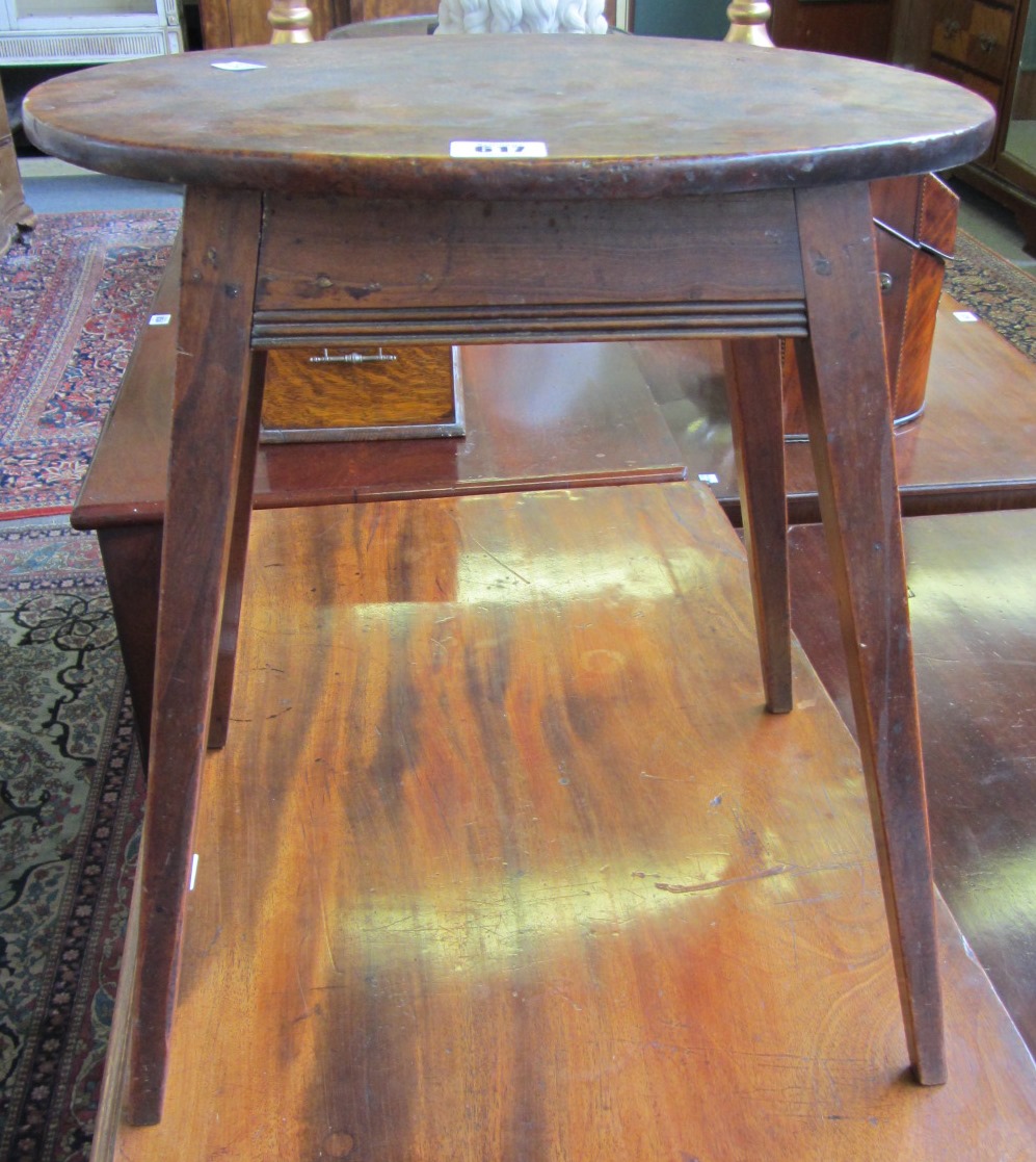 Appraisal: An th century small fruitwood oval occasional table on tapering