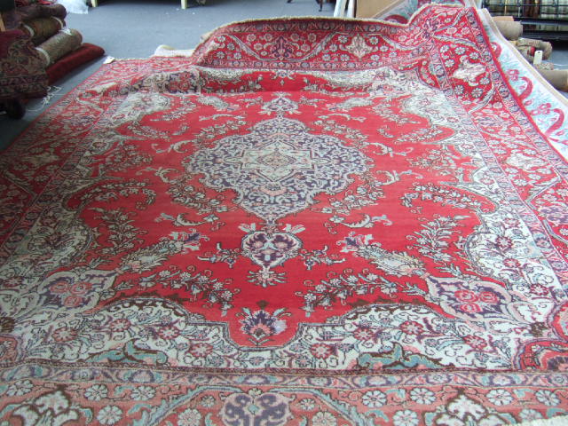 Appraisal: A Tabriz carpet Persian the madder field with a bold