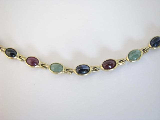 Appraisal: A K yellow gold link bracelet with bezel set cabochon