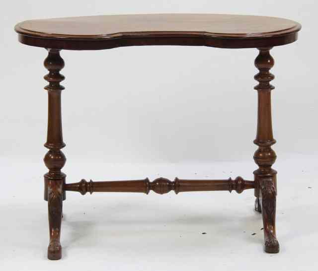 Appraisal: A late Victorian kidney shaped table on turned end standards