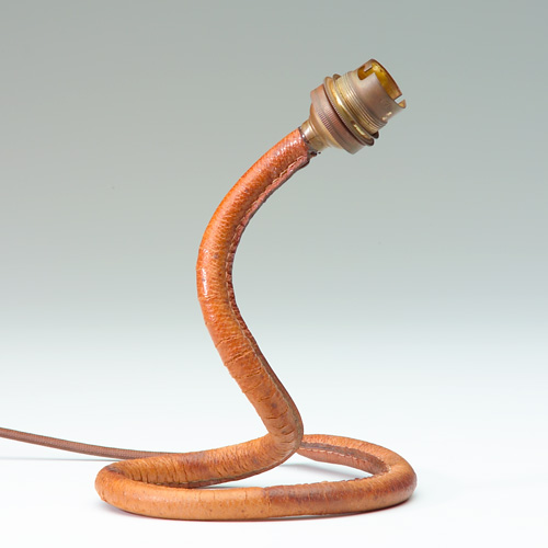 Appraisal: JACQUES ADNET Serpent coiled desk lamp with brown leather sheath