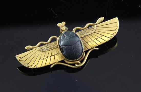 Appraisal: An Egyptian Revival gold mounted carved lava winged scarab brooch