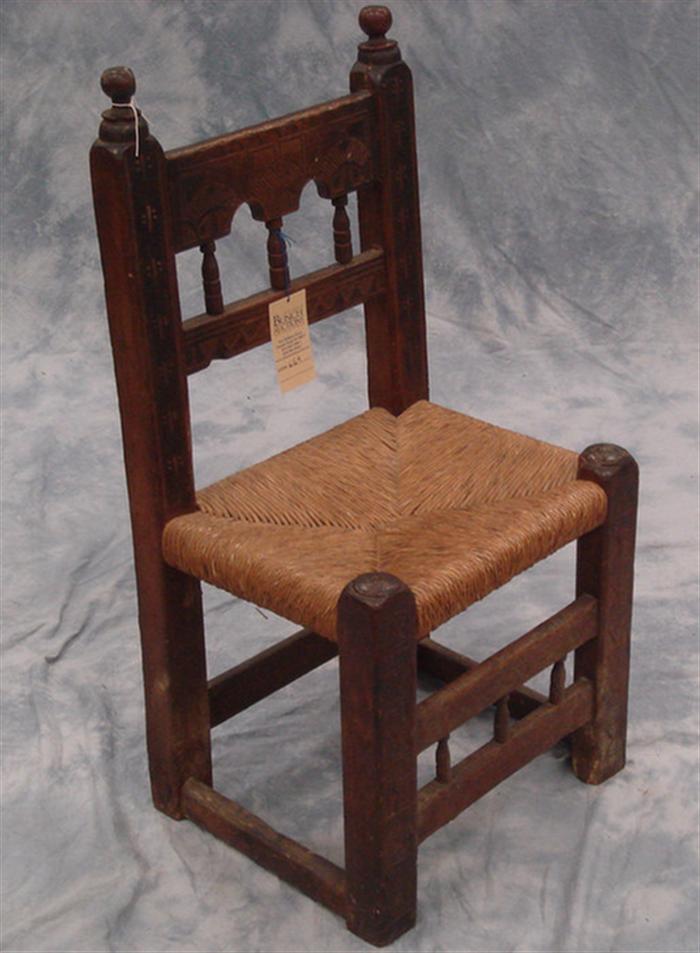 Appraisal: Carved pine Continental side chair with rush seat -spindled back