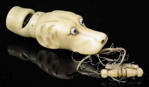 Appraisal: A th Century bone dog whistle carved as the head