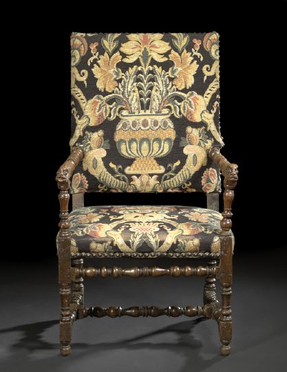 Appraisal: Jacobean-Style Carved Walnut Armchair early th century the padded rectangular