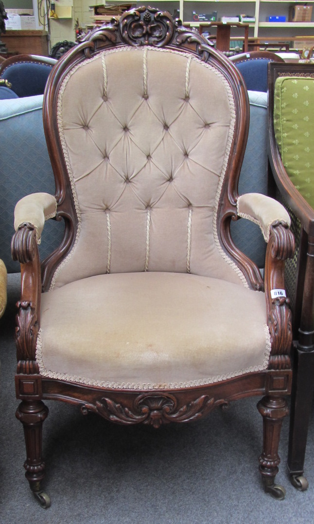 Appraisal: A Victorian mahogany framed spoonback armchair with semi padded arms