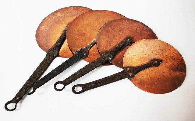 Appraisal: A SET OF FOUR GRADUATED COPPER AND IRON HANDLED SAUCEPAN