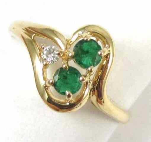 Appraisal: EMERALD DIAMOND AND FOURTEEN KARAT GOLD RING set with two