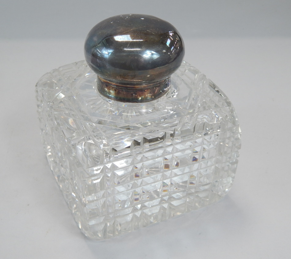 Appraisal: A cut glass square section inkwell with a hinged silver