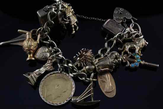 Appraisal: A ct gold charm bracelet hung with sixteen associated charms