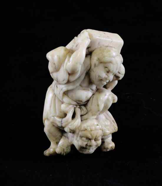 Appraisal: A Japanese bone netsuke of Shoki on an oni's back