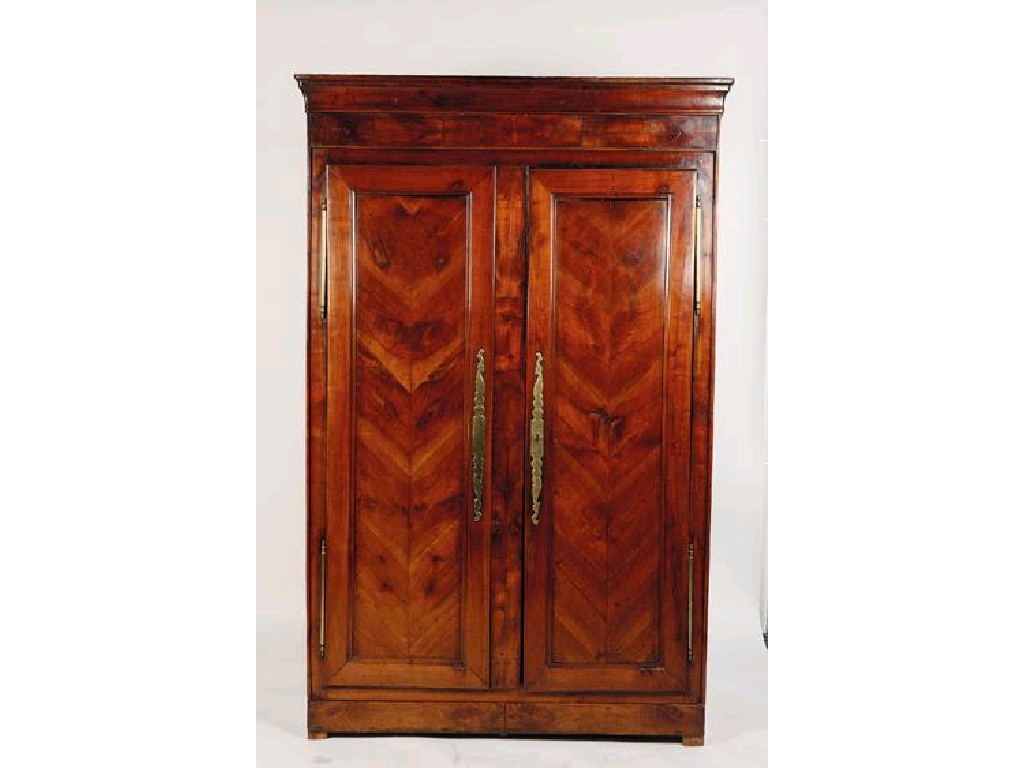 Appraisal: A FRENCH WALNUT ARMOIRE with a moulded cornice above twin