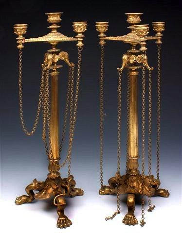 Appraisal: A PAIR OF GILT METAL CANDLESTICKS with long fluted stems