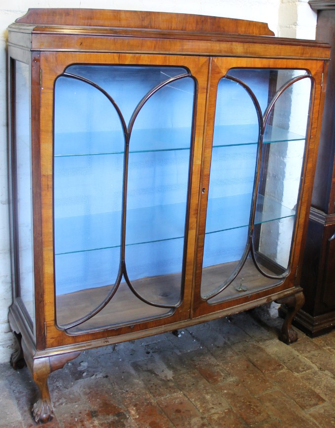 Appraisal: A mid thC walnut double door display cabinet the astragal