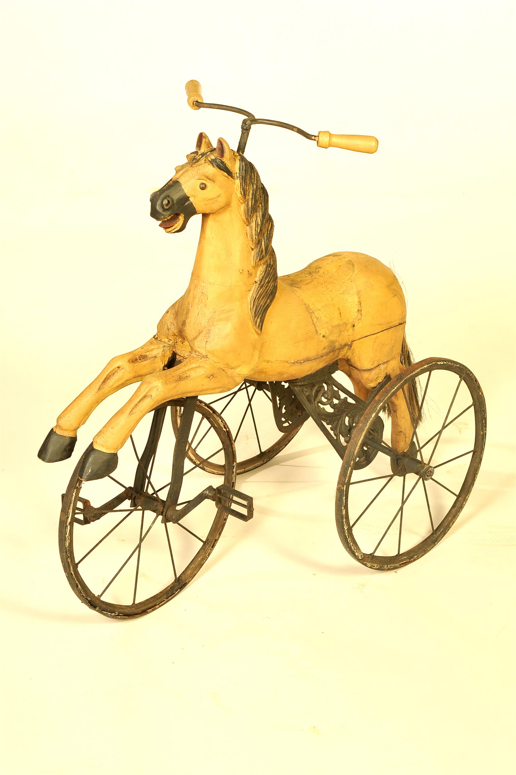 Appraisal: HORSE TRICYCLE Twentieth century Full-bodied carved wood horse with beige