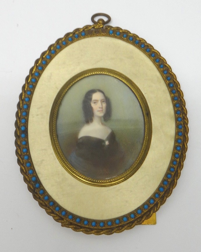 Appraisal: An oval portrait miniature of a lady with curly black