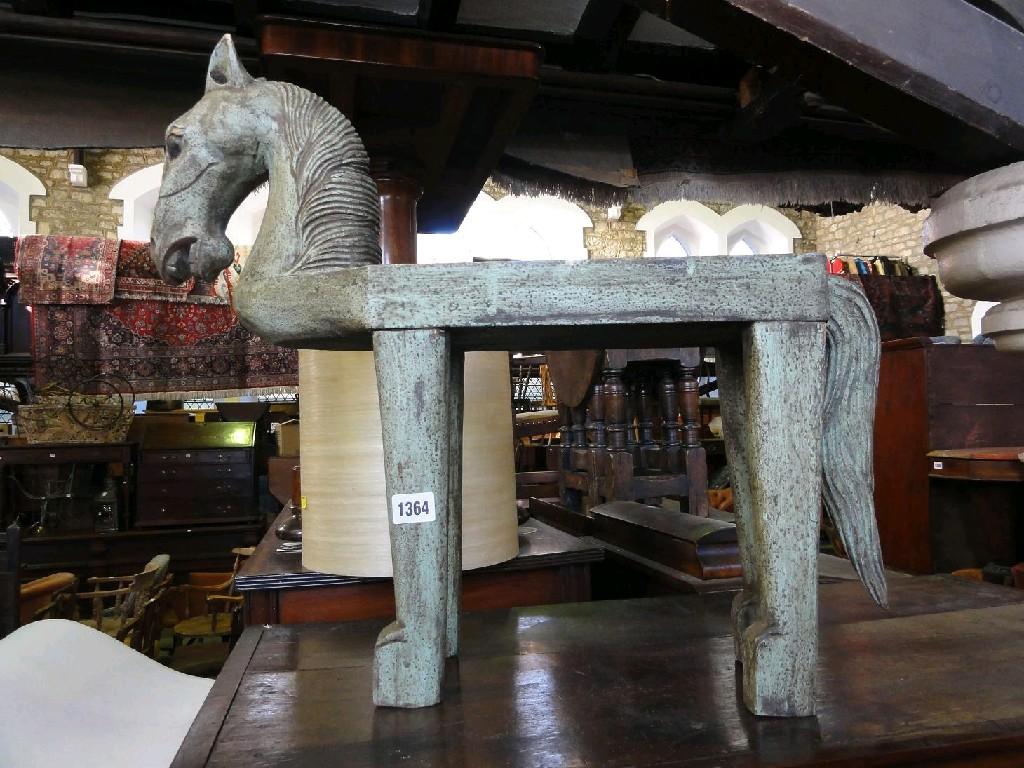 Appraisal: A carved timber stool in the form of a horse