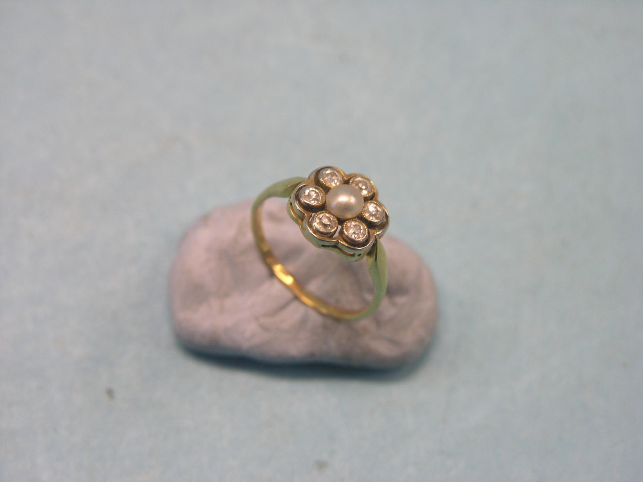 Appraisal: A yellow metal rosette ring set six small diamonds and