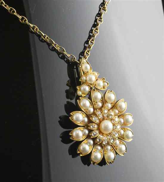 Appraisal: A gold diamond and pearl flowerhead pendant on fine link