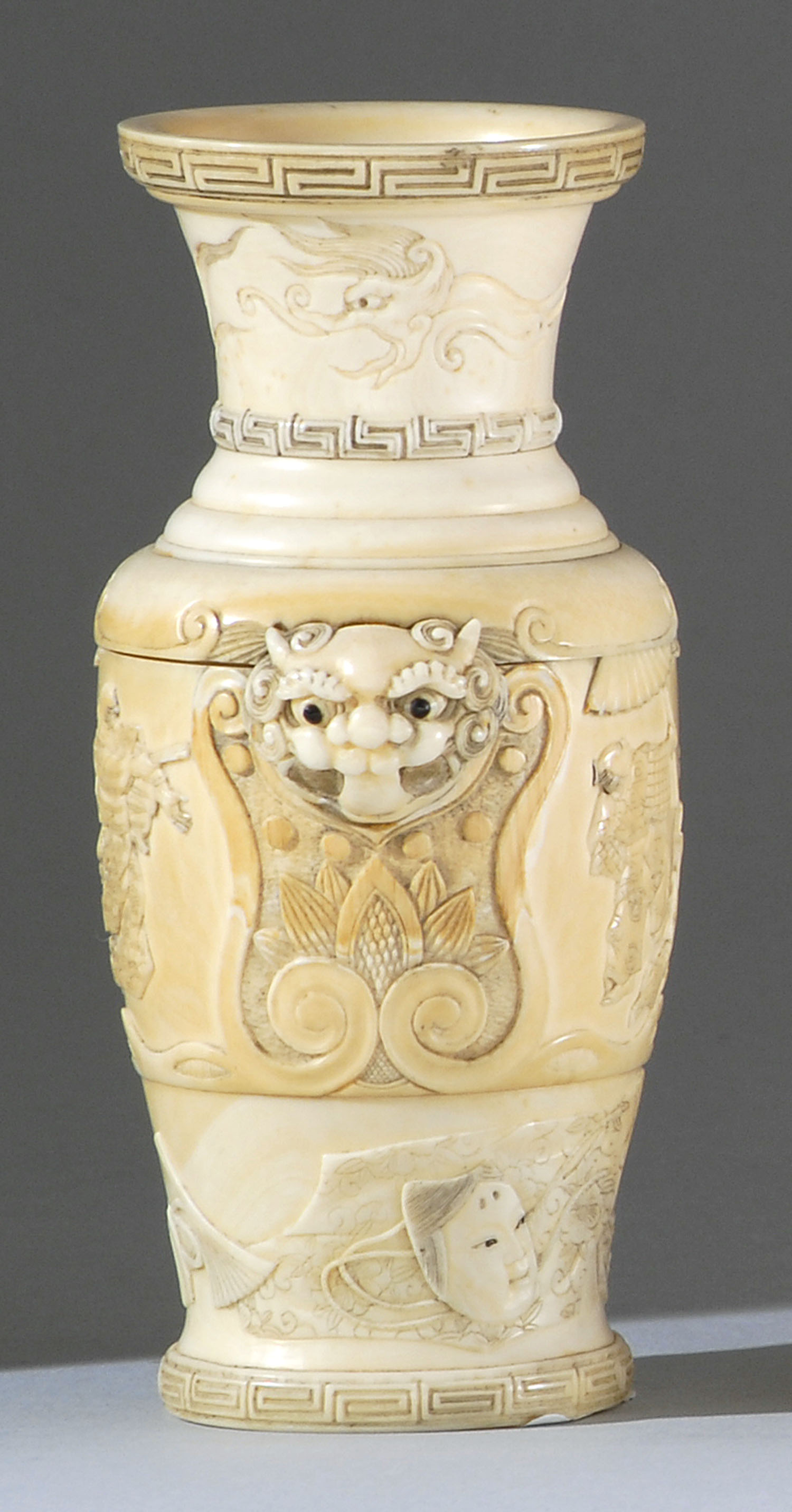 Appraisal: IVORY VASE Meiji PeriodIn baluster form with oni's-head handles Body