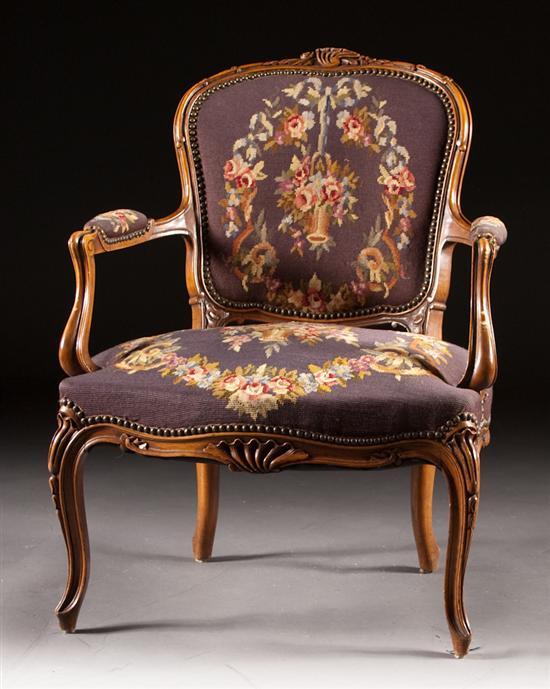 Appraisal: Louis XV style carved fruitwood needlepoint upholstered fauteuil th century