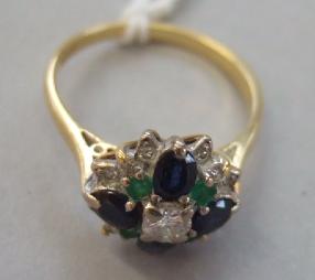 Appraisal: A gold diamond sapphire and emerald set cluster ring mounted