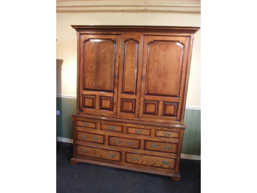 Appraisal: A modern oak and mahogany cross banded press cupboard the