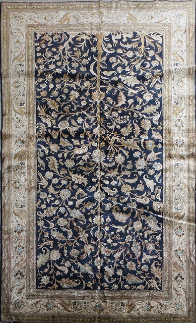 Appraisal: A PERSIAN QUM SILK SMALL CARPET decorated with a central