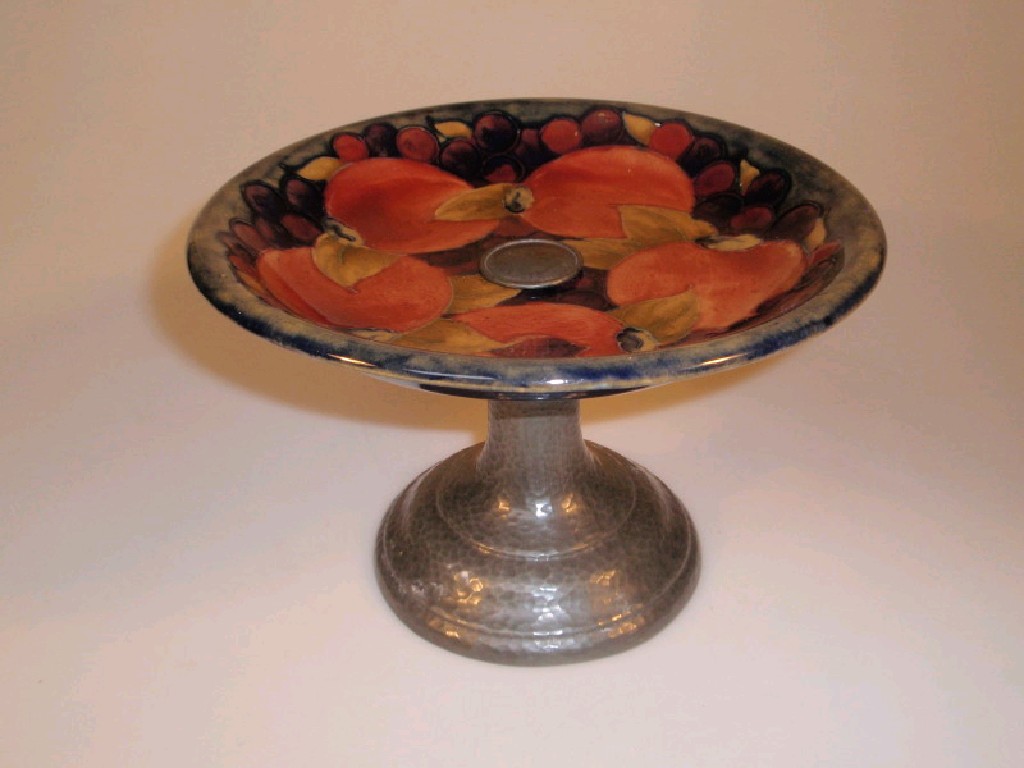 Appraisal: A Moorcroft pottery tazza on a swept planished pewter column