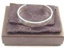 Appraisal: A Gucci silver bangle in original box and pouch