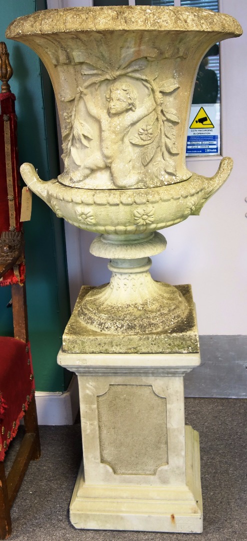 Appraisal: A reconstituted stone jardiniere with cherub moulded body on a