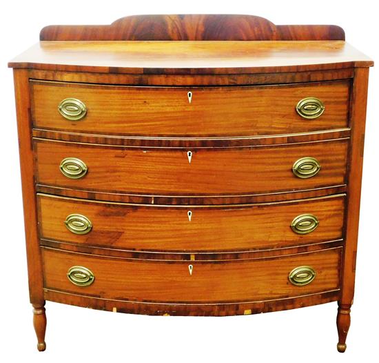 Appraisal: Bow front chest of drawers Sheraton cherry with mahogany finish