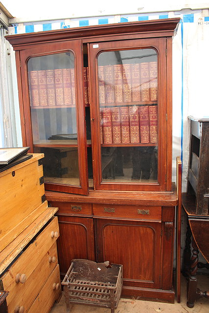 Appraisal: A VICTORIAN MAHOGANY LIBRARY BOOKCASE CABINET with glazed doors above