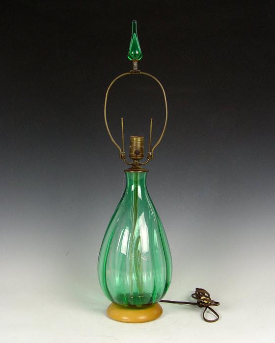 Appraisal: BLENKO BLOWN GLASS LAMP Clear green glass base on wooden