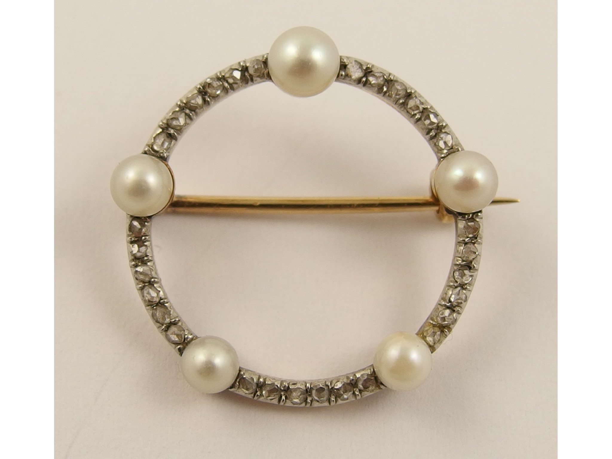 Appraisal: A diamond and pearl circle broochset with full pearls and