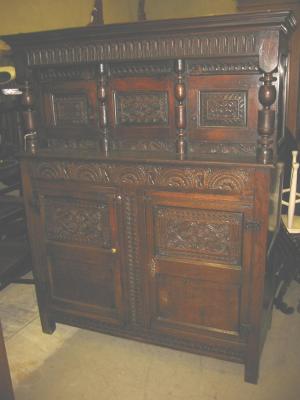 Appraisal: AN OAK PRESS CUPBOARD the canopy with moulded cornice over