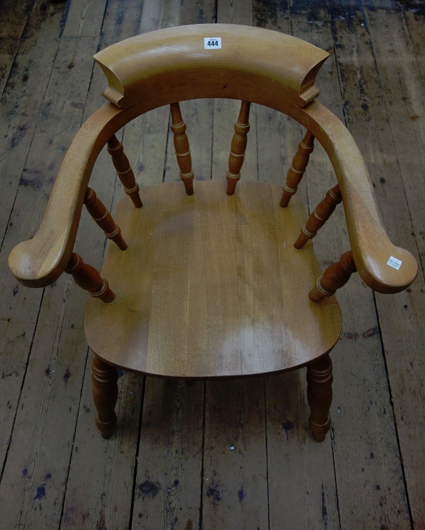 Appraisal: A reproduction Victorian style smokers bow elbow chair with solid