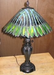 Appraisal: A TIFFANY STYLE STAINED AND LEADED GLASS LAMP two-light in